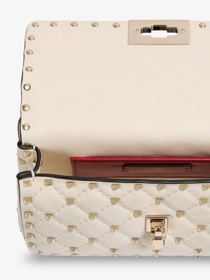 Valentino Garavani Rockstud Spike leather shoulder bag with iconic all-over studs - Lightivory